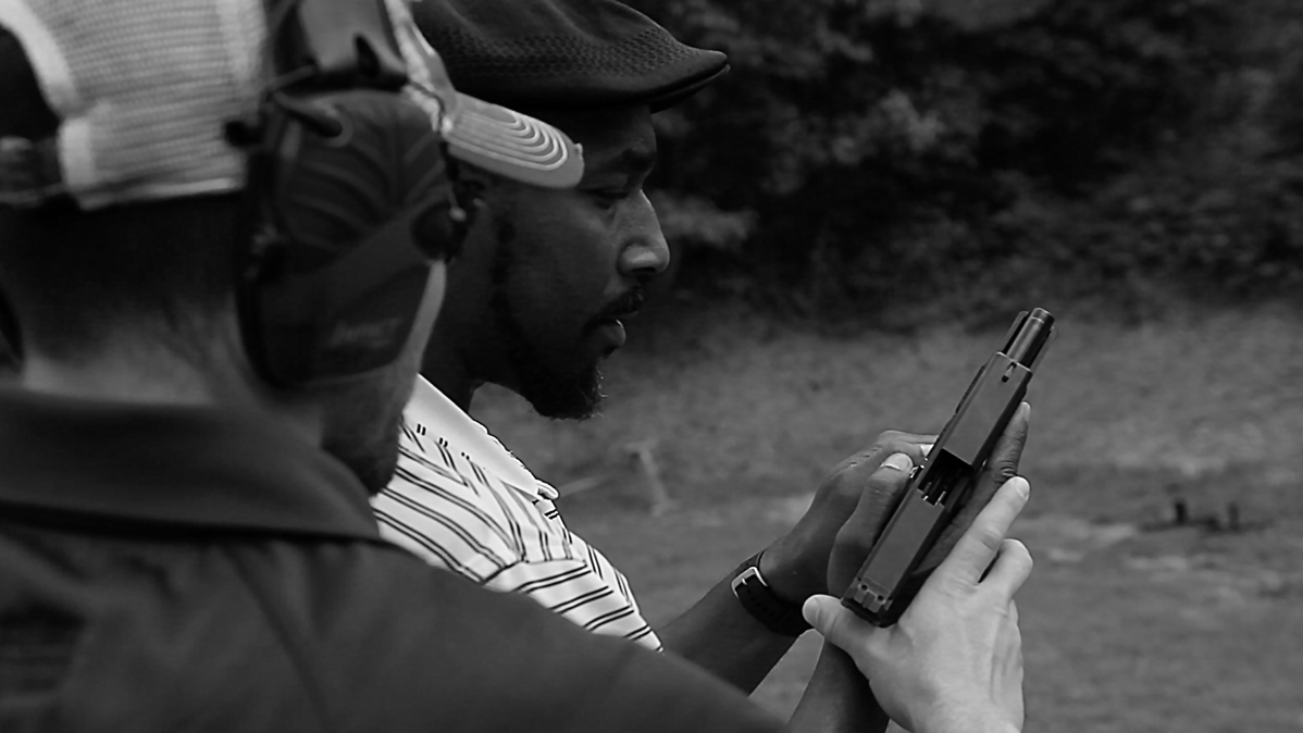 CCW instructor teaching concealed carry student how to load a handgun properly.